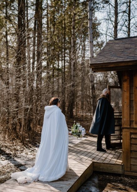 Lexi and Matt enter their cabin in their wedding capes.