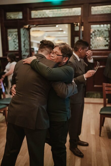 The grooms hug David's parents after their emotional ceremony.