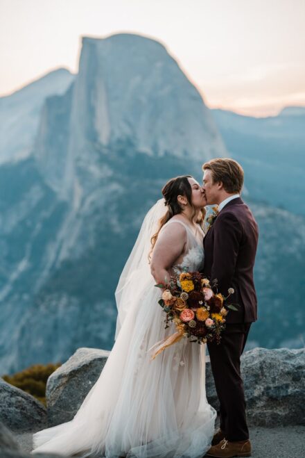 Kevin and Allison share a kiss in front of Half Dome during their first look.