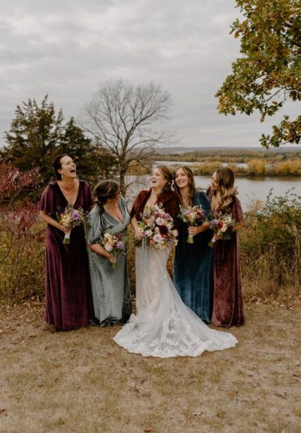Surrounded by her bridesmaids, Laura laughs at a joke.