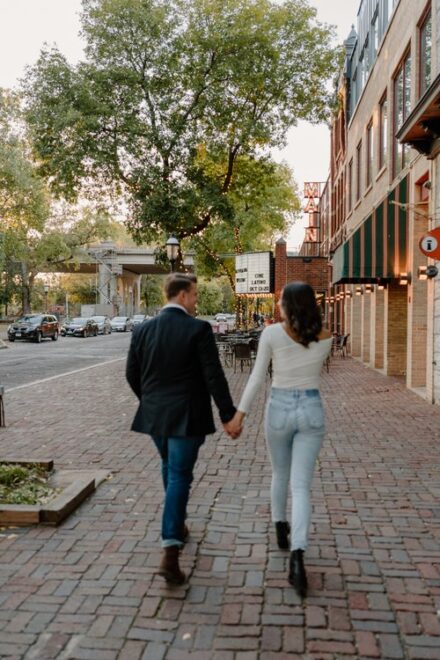 Ashley and Ehren walk hand in hand toward the St. Anthony Main Theater.