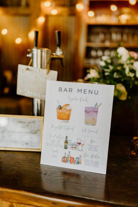 A watercolor painted bar menu advertising old fashioneds and lavender lemonade.