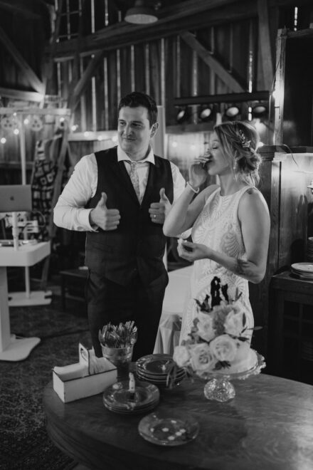 Jake gives a thumbs up and Sarah laughs as they eat their wedding cake.