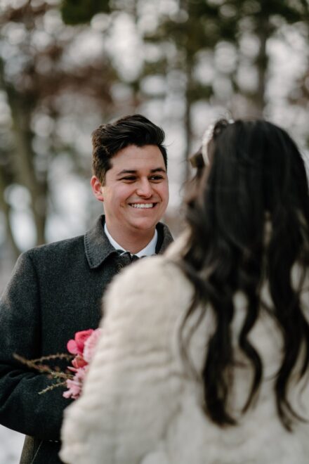 A close up photo of a groom smiling during an elopement ceremony.