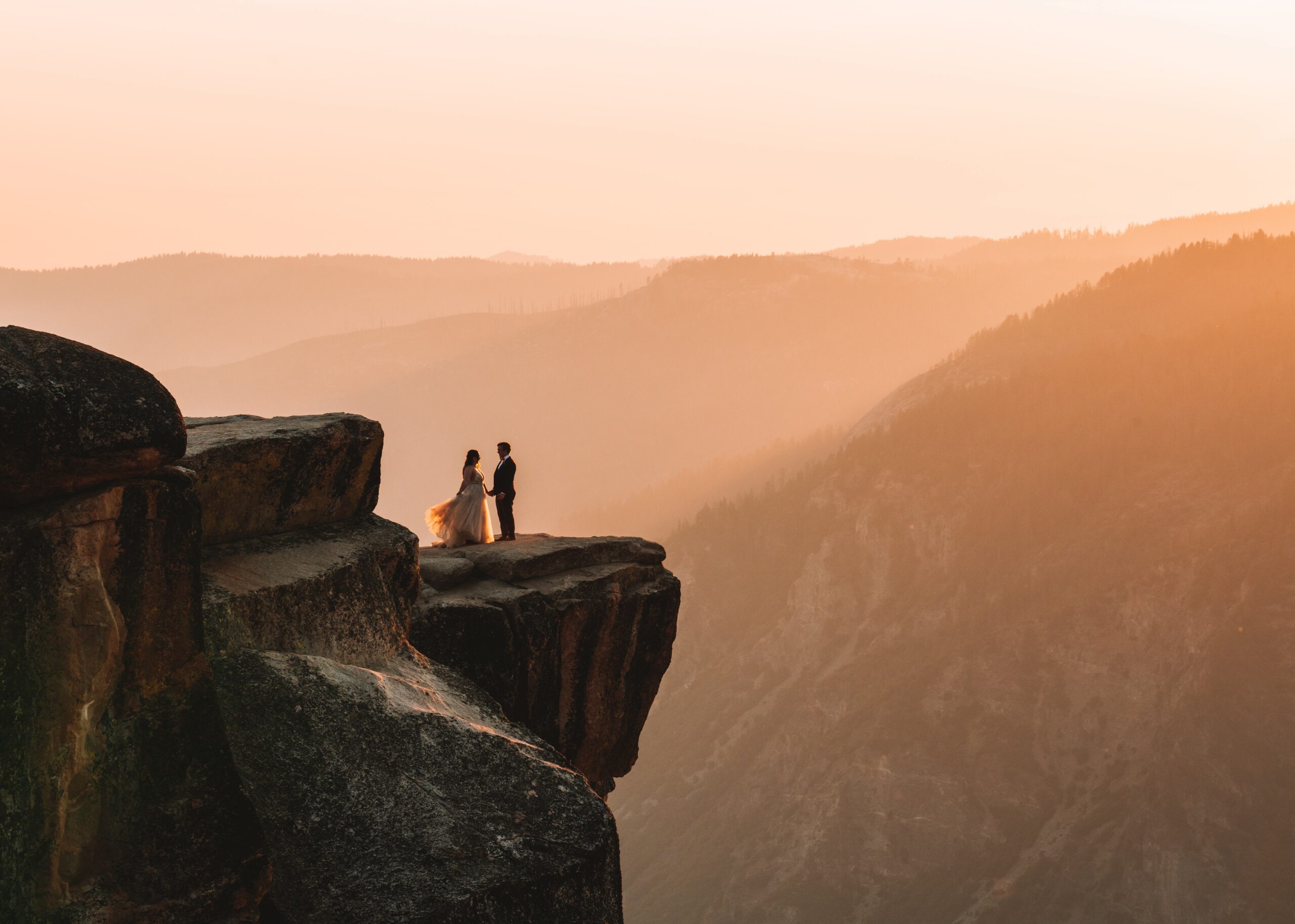 A couple eloping on a cliff at Sunset in Yosemite National Park