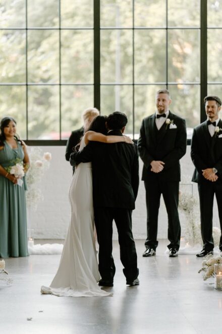 A bride hugging her father before her wedding ceremony.