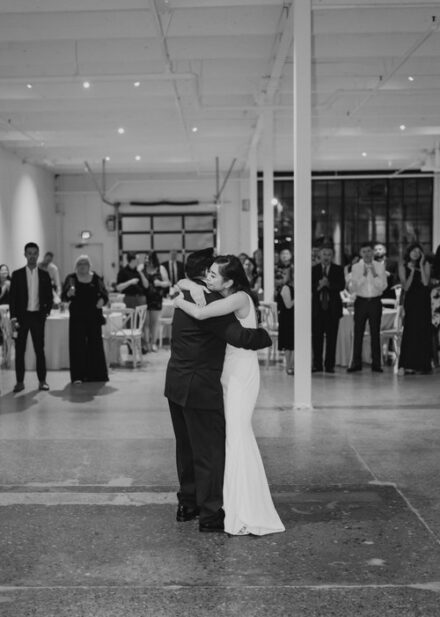 A black and white photo of the bride hugging her father after the father/daughter dance.