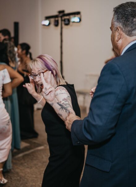 A wedding guest dancing.