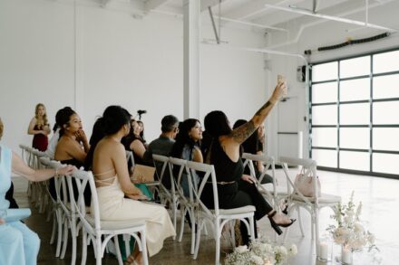A group of wedding guests taking a selfie before the ceremony.