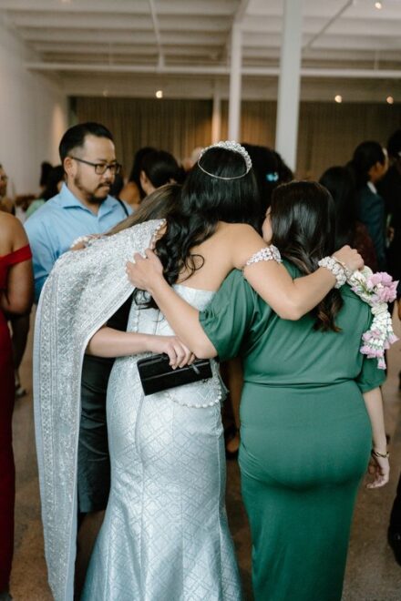 The bride hugging some of the wedding guests.