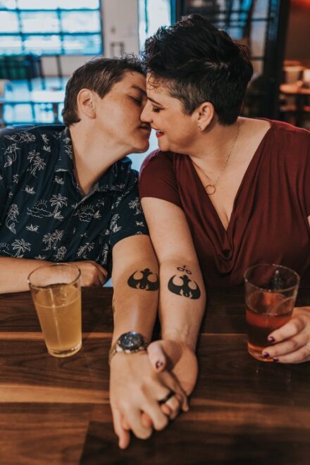 Abby and Jill show off their matching Star Wars tattoos as they lean in for a kiss.