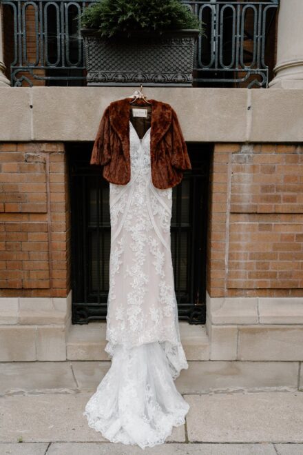 A lacy wedding dress hanging on a ledge in front of the Celeste Hotel in St. Paul.