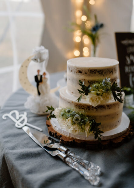 Anna and Jason's naked wedding cake with neutral flowers.