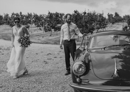Anna and Jason walk away from the Porsche and enter the wedding reception.