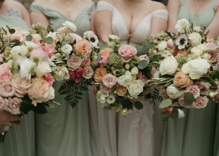 Connie's bridesmaids show off their pink, green, and white bouquets.