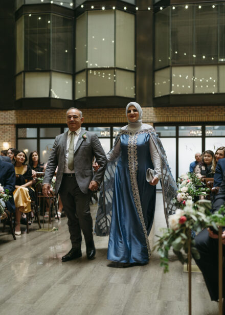 Taysir's parents walk down the aisle before the ceremony.