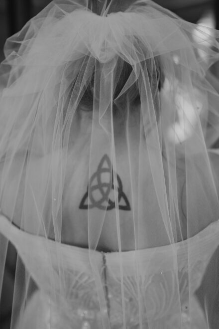 A close up of Connie's tattoo through the tulle of her veil.