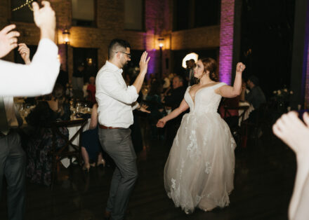 The wedding couple dances together.