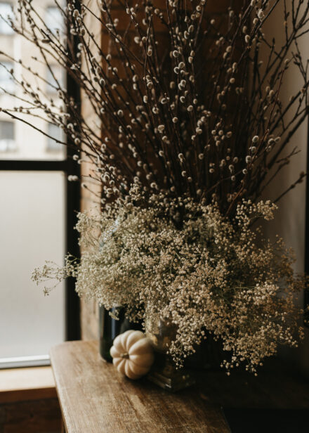 Baby's breath and branches adorn the corner of the private dining room.