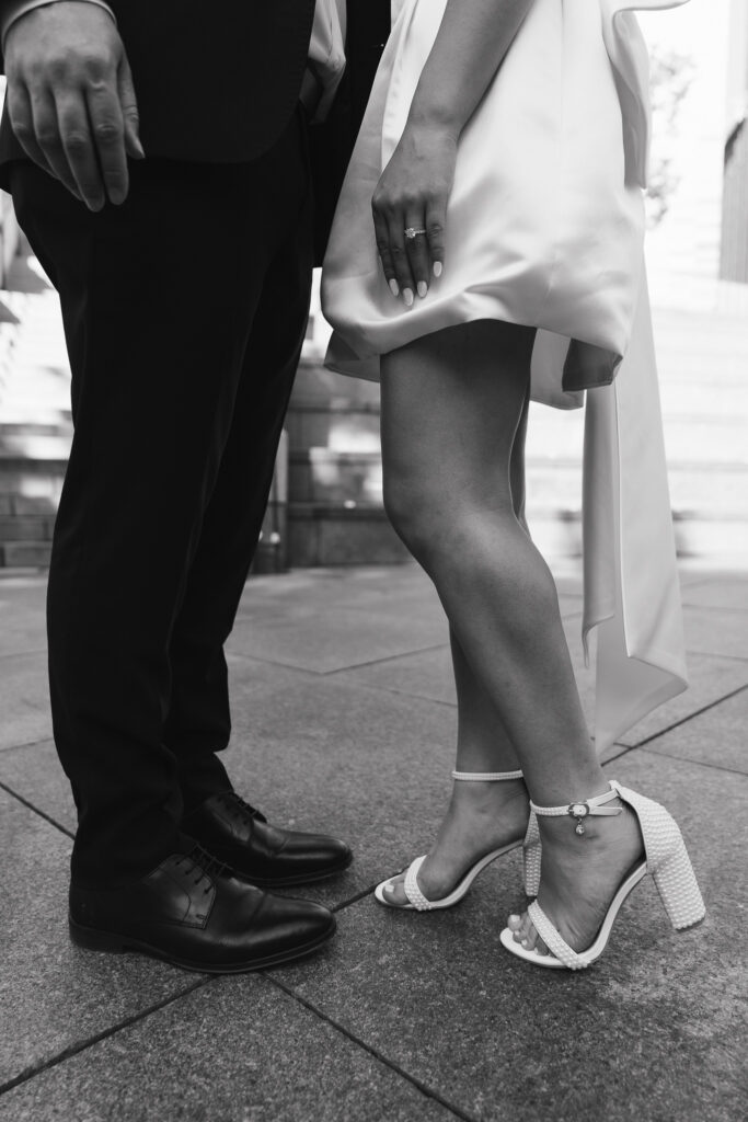 A close up of the couple's shoes in front of the Chicago Riverwalk.