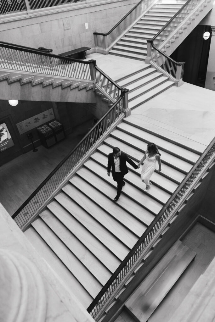 A shot from above of the couple walking down the grand staircase at the Art Institute of Chicago.