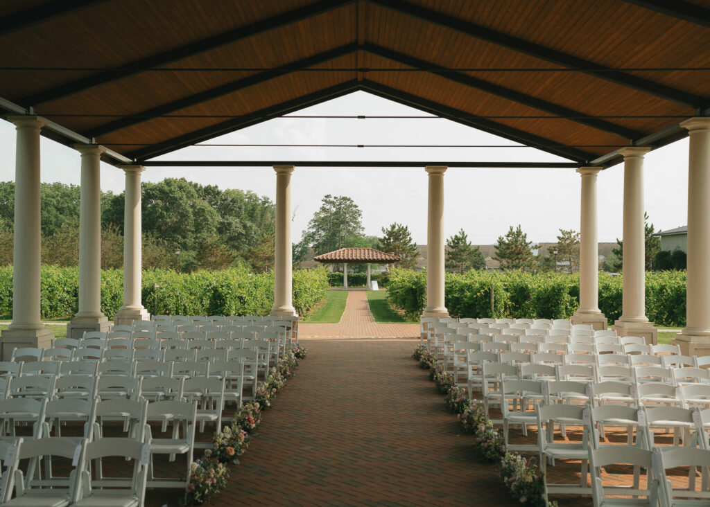 The view of empty chairs and sprawling vineyard from the front of the pavilion.