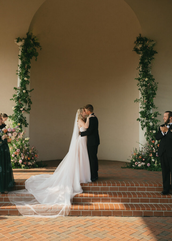 The couple shares their first kiss at the end of their wedding ceremony.