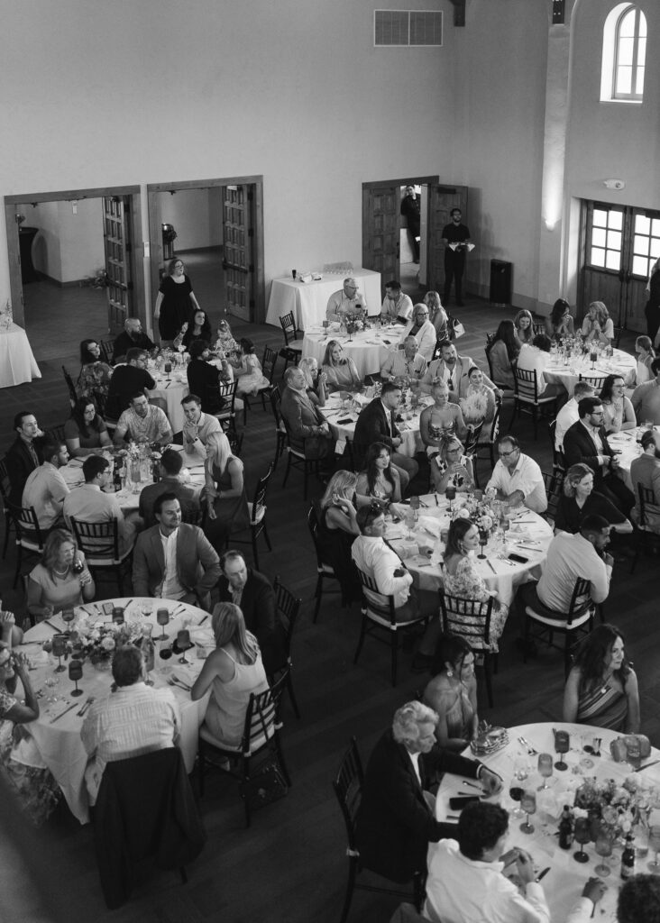 Guests mingle at round dinner tables during the reception.