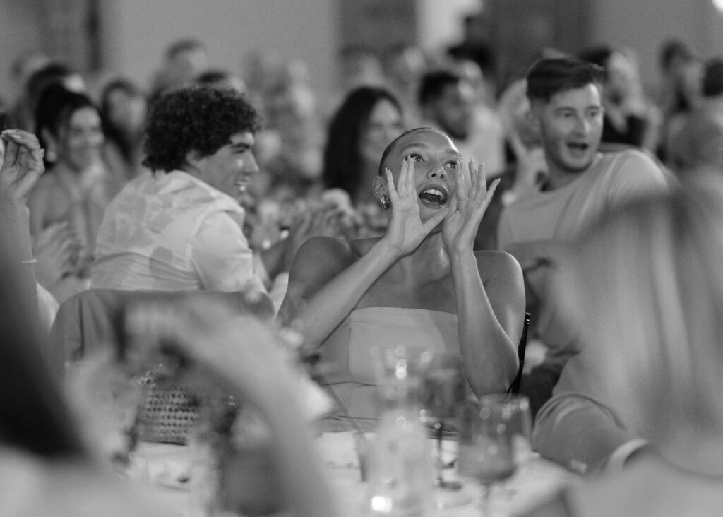 A wedding guest shouts in celebration during a speech.